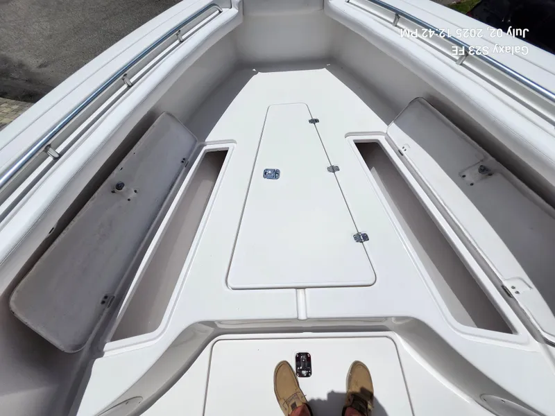 Slide: The Image of 2010 Donzi 29ZF boat deck with storage compartments and railings. - 21