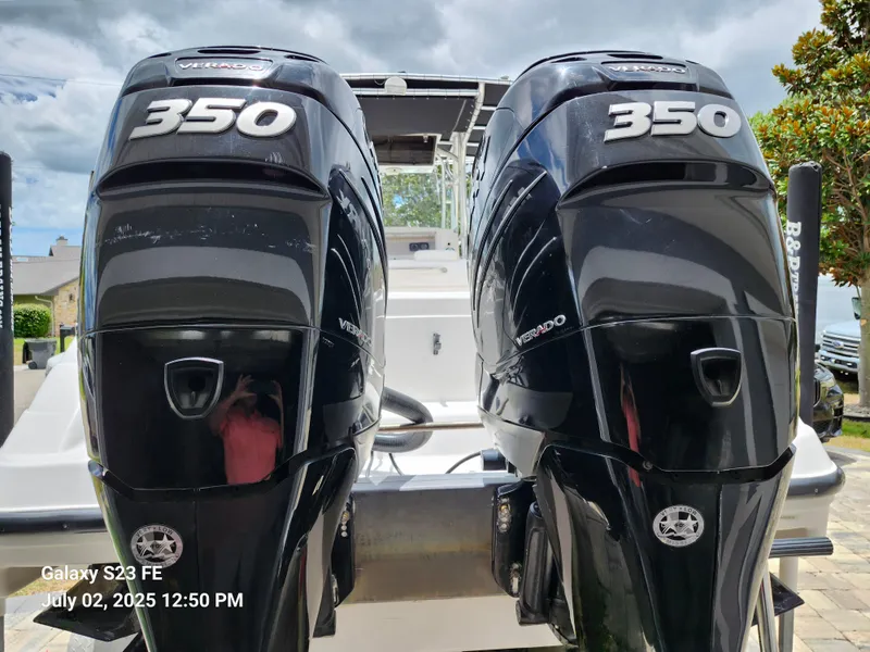 Slide: The Image of Twin Mercury Verado 350 engines on a 2010 Donzi 29ZF boat, parked outdoors. - 5