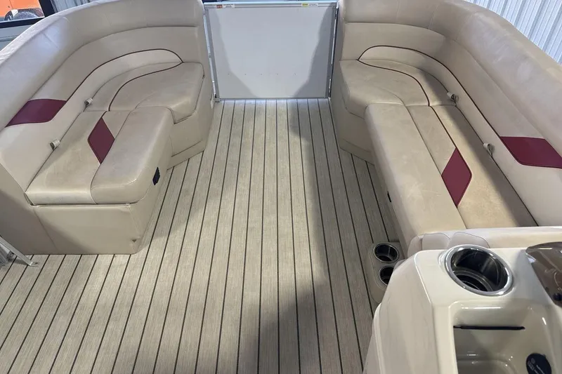 Slide: The Image of Interior of 2021 SunCatcher Select 20C pontoon boat with beige seating and striped flooring. - 11