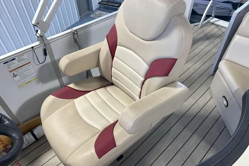 Slide: The Image of Captain's chair on 2021 SunCatcher Select 20C boat, featuring beige and red upholstery. - 13