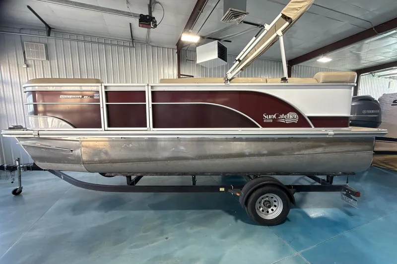 Slide: The Image of 2021 SunCatcher Select 20C pontoon boat on trailer in indoor storage. - 2