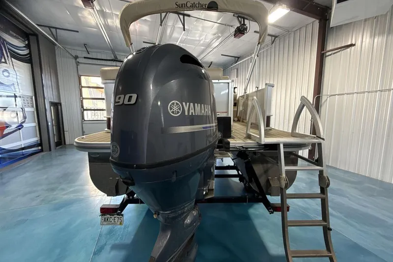 Slide: The Image of 2021 SunCatcher Select 20C pontoon boat with Yamaha 90 engine in a garage. - 4