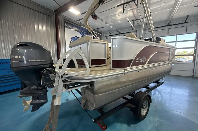 Slide: The Image of 2021 SunCatcher Select 20C pontoon boat with Yamaha outboard motor in a garage. - 5