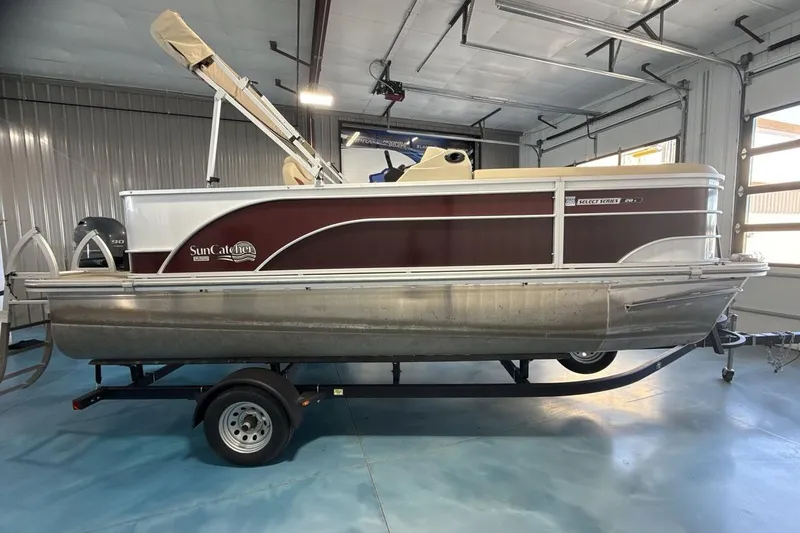 Slide: The Image of 2021 SunCatcher Select 20C pontoon boat in a garage setting. - 6