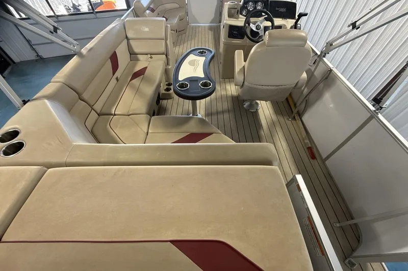 Slide: The Image of Interior of a 2021 SunCatcher Select 20C pontoon boat with beige seating and steering console. - 9