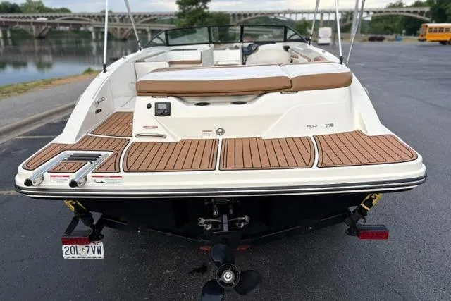 Slide: The Image of 2017 Searay SPX210 boat with teak deck, parked near a waterfront. - 11