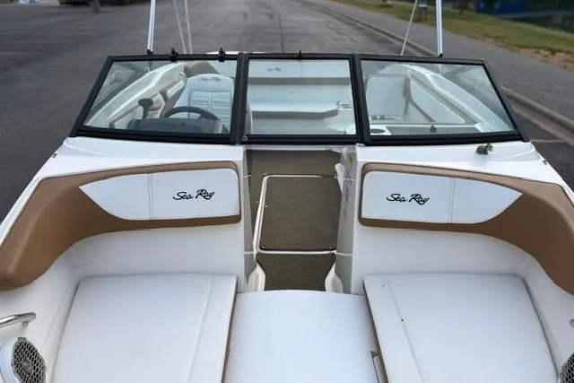 Slide: The Image of 2017 Searay SPX210 boat interior with tan and white seating, open deck view. - 15