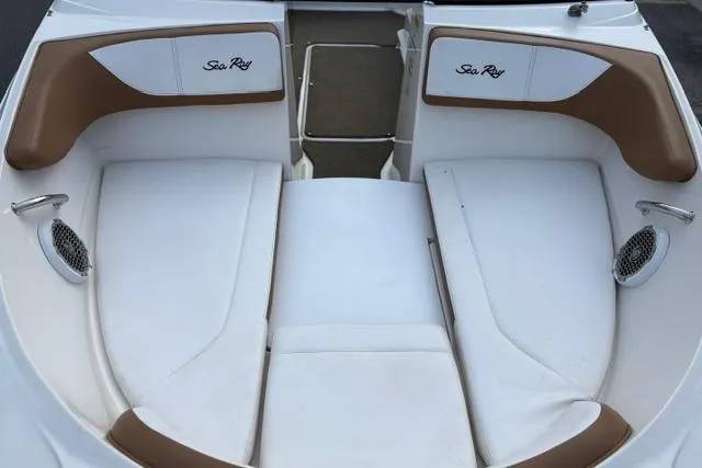 Slide: The Image of 2017 Searay SPX210 boat interior with white and brown seating, featuring Sea Ray branding. - 16