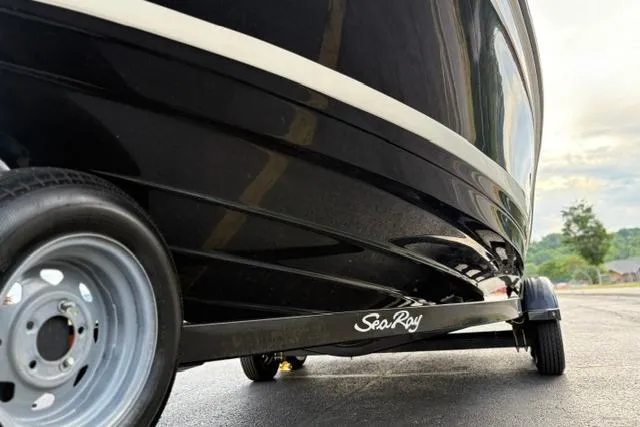 Slide: The Image of 2017 Searay SPX210 boat on trailer, showcasing sleek black hull design. - 18