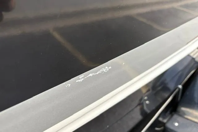 Slide: The Image of Close-up of 2017 Searay SPX210 boat surface with minor paint damage. - 19