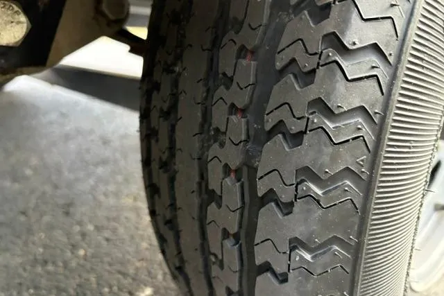 Slide: The Image of Close-up of a 2017 Searay SPX210 tire with detailed tread pattern. - 22
