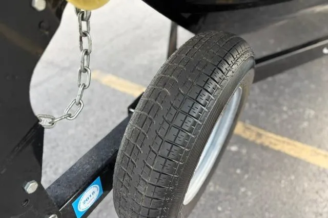 Slide: The Image of Trailer wheel of a 2017 Searay SPX210 boat, featuring a sturdy chain attachment. - 25