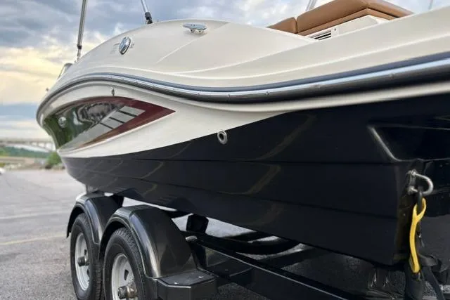 Slide: The Image of 2017 Searay SPX210 boat on trailer, side view with sleek design. - 27