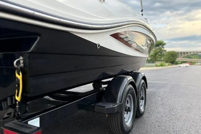 Slide: The Image of 2017 Searay SPX210 boat on trailer in parking lot, overcast sky. - 28