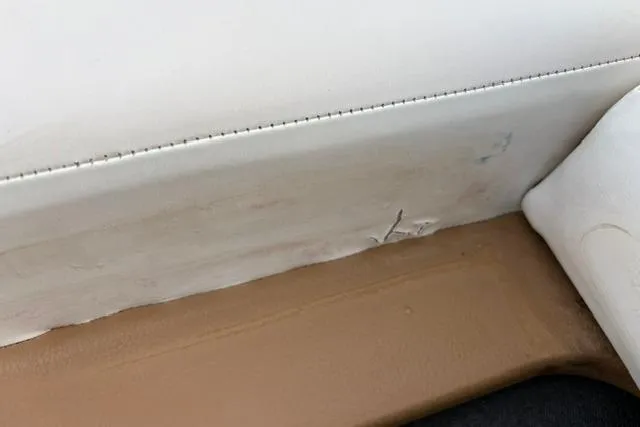 Slide: The Image of Interior detail of 2017 Searay SPX210 boat showing upholstery stitching and minor wear. - 30