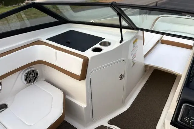 Slide: The Image of 2017 Searay SPX210 boat interior with seating, storage, and cup holder. - 33