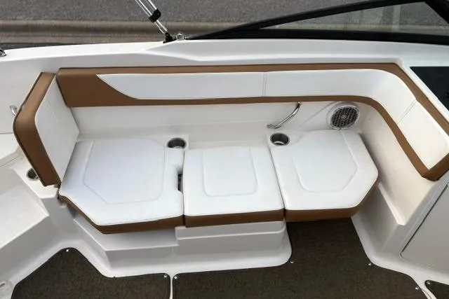 Slide: The Image of 2017 Searay SPX210 boat interior seating with white and brown upholstery. - 34
