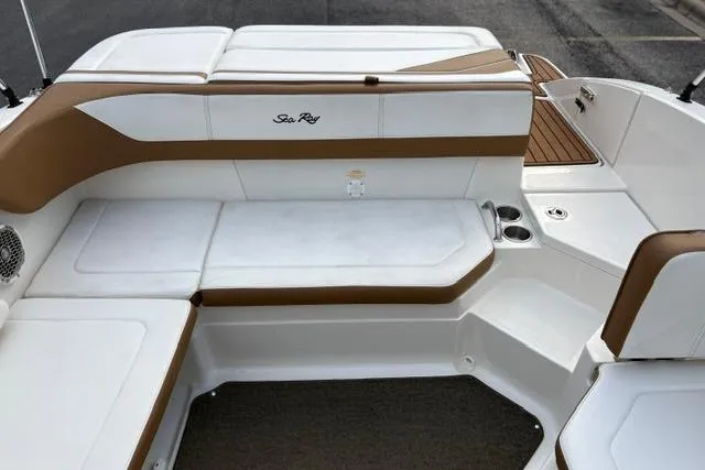 Slide: The Image of 2017 Searay SPX210 boat interior with white and brown seating, cup holders, and deck view. - 35