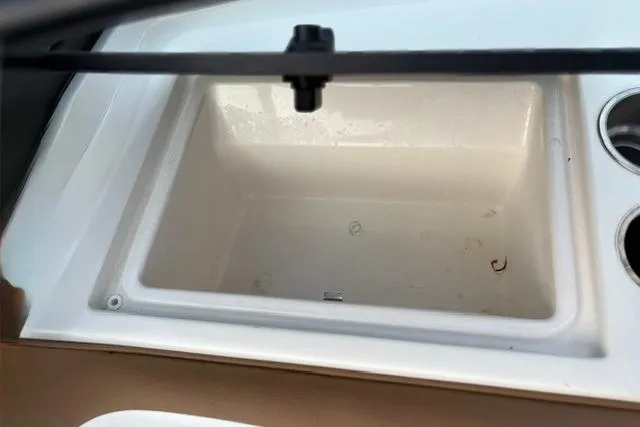 Slide: The Image of 2017 Searay SPX210 boat cooler compartment with cup holders. - 37