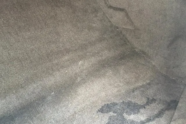 Slide: The Image of Interior carpet of a 2017 Searay SPX210 boat, showing wear and stains. - 39