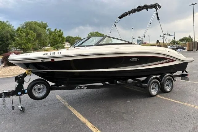Slide: The Image of 2017 Searay SPX210 boat on trailer in parking lot, overcast sky. - 4