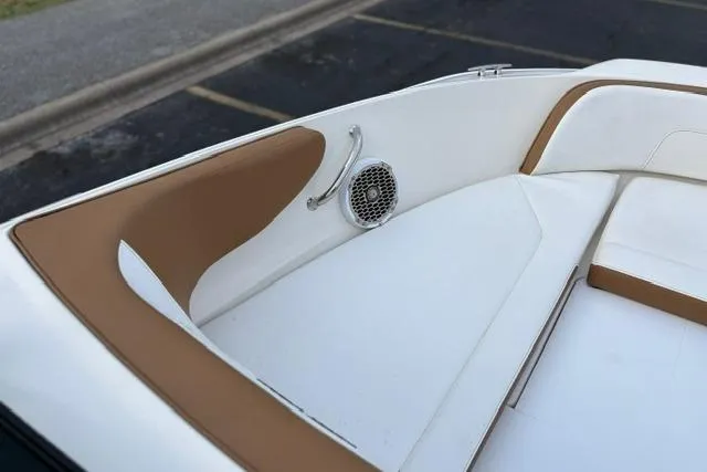Slide: The Image of 2017 Searay SPX210 boat interior with tan and white seating, featuring a speaker. - 43