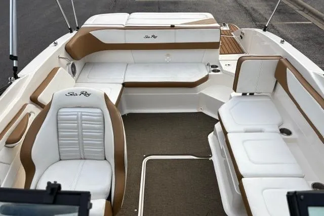 Slide: The Image of 2017 Searay SPX210 boat interior with white and brown seating, spacious layout. - 44