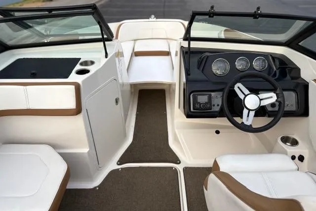 Slide: The Image of 2017 Searay SPX210 boat interior with steering wheel and seating area. - 48
