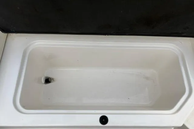 Slide: The Image of Storage compartment of a 2017 Searay SPX210 boat, featuring a clean, white interior. - 51