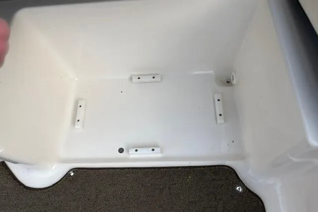 Slide: The Image of Storage compartment of a 2017 Searay SPX210 boat, featuring a clean, white interior. - 53