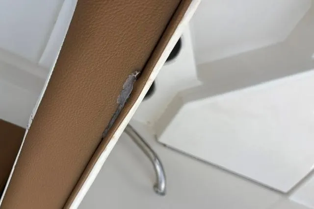 Slide: The Image of 2017 Searay SPX210 boat seat with visible upholstery damage. - 55