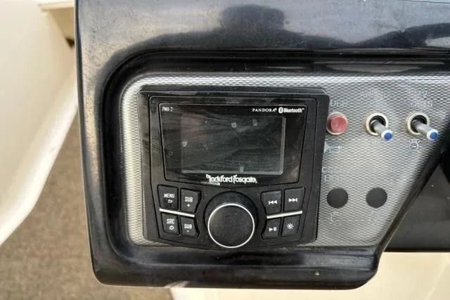 Slide: The Image of Rockford Fosgate audio system on 2017 Searay SPX210 boat dashboard with Bluetooth connectivity. - 57