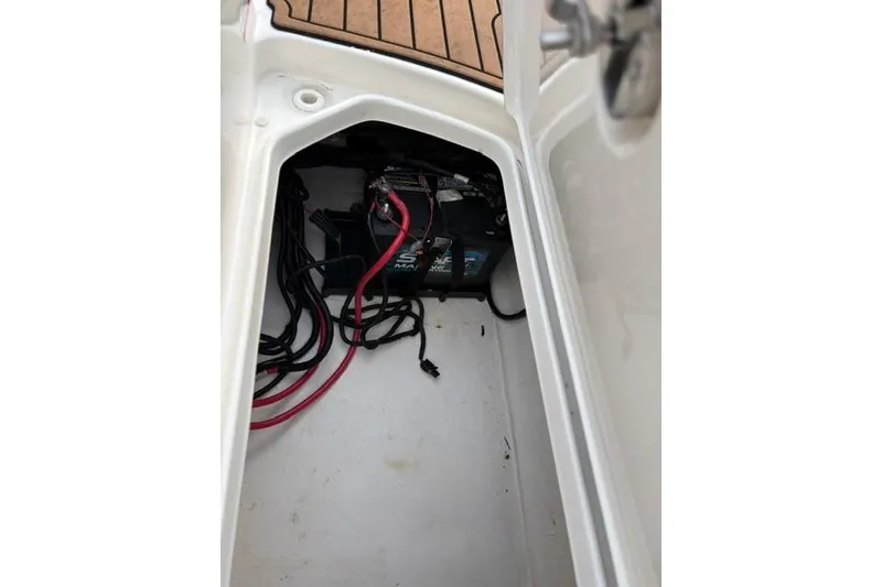 Slide: The Image of 2017 Searay SPX210 boat battery compartment with cables and wiring. - 60