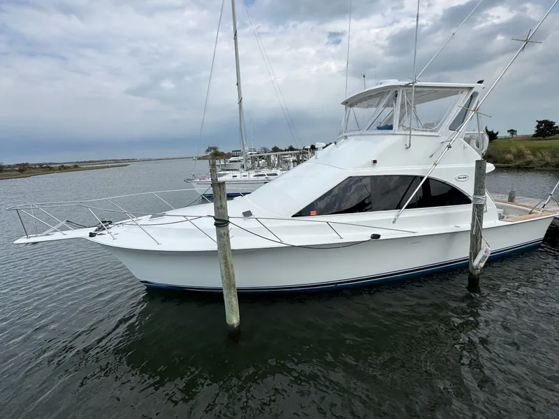 Slide: The Image of 1995 Ocean Yachts 42 SS docked, cloudy sky. - 1