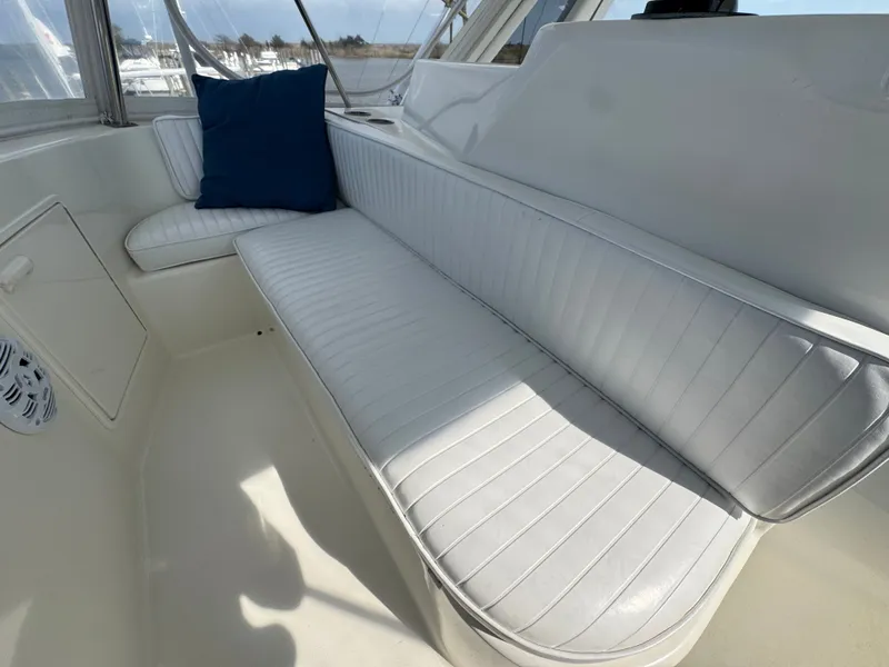 Slide: The Image of 1995 Ocean Yachts 42 SS interior with white seating area. - 16