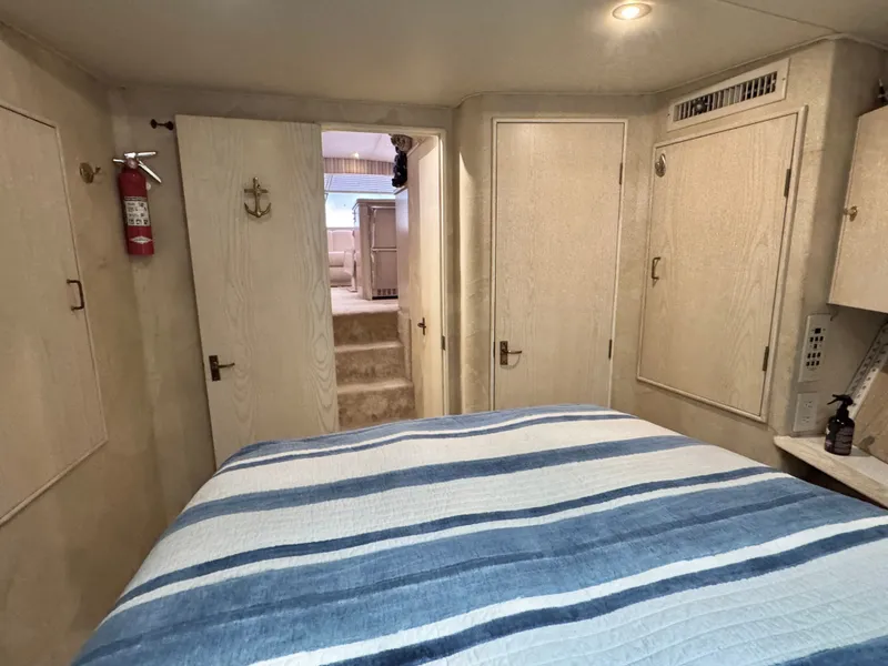 Slide: The Image of Interior of a 1995 Ocean Yachts 42 SS with striped bedding. - 47