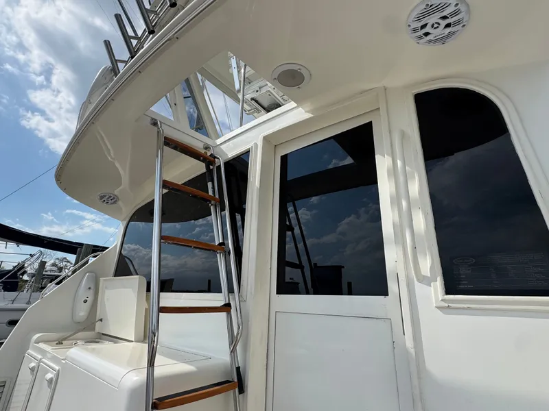 Slide: The Image of 1995 Ocean Yachts 42 SS with ladder and window, sunny sky. - 6