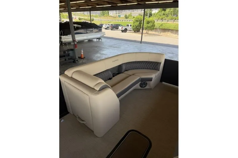 Slide: The Image of 2025 Harris Sunliner 230 pontoon boat with luxurious seating under a covered dock. - 14