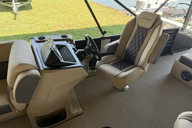 Slide: The Image of 2025 Harris Sunliner 230 boat interior with luxurious seating and modern helm controls. - 8