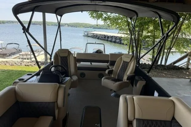 Slide: The Image of 2025 Harris Sunliner 230 pontoon boat interior with lake view and comfortable seating. - 9