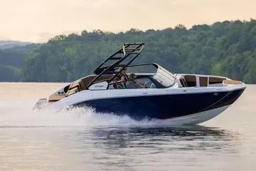 Slide: The Image of 2026 Yamaha Boats 222SE cruising on a serene lake with lush green backdrop. - 11