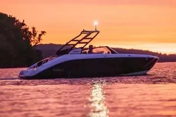 Slide: The Image of 2026 Yamaha Boats 222SE cruising at sunset on a serene lake. - 9