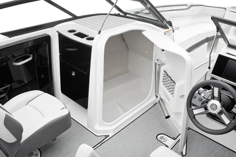 Slide: The Image of Manufacturer Provided Image: 2026 Yamaha Boats AR250 interior with helm, seating, and storage compartment. - 7