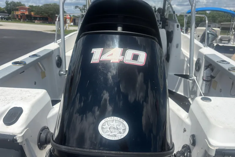 Slide: The Image of 1994 Trophy 1802 Walkaround boat with a 140 HP outboard motor, docked outdoors. - 10