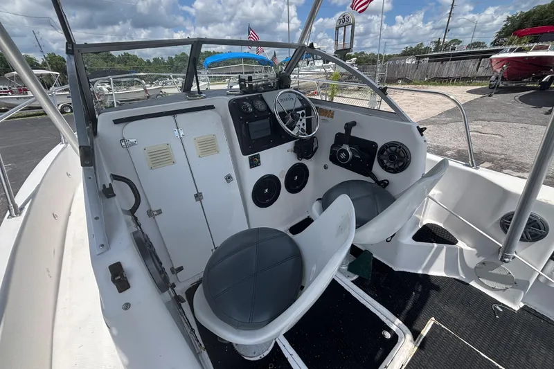 Slide: The Image of 1994 Trophy 1802 Walkaround boat interior with steering wheel and seating. - 12