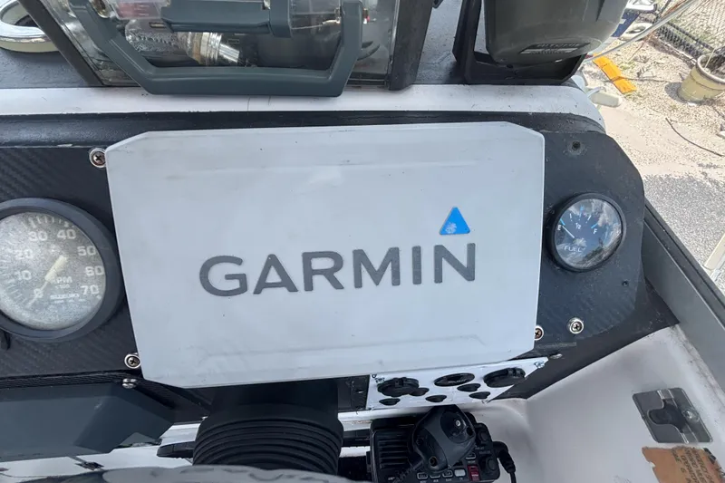 Slide: The Image of Dashboard of a 1994 Trophy 1802 Walkaround boat featuring Garmin navigation equipment. - 14