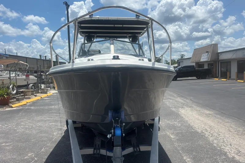 Slide: The Image of 1994 Trophy 1802 Walkaround boat on trailer under a cloudy sky. - 8
