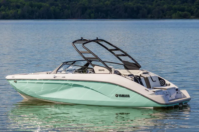Slide: The Image of Manufacturer Provided Image: 2026 Yamaha Boats 222S on serene lake with lush forest backdrop. - 4