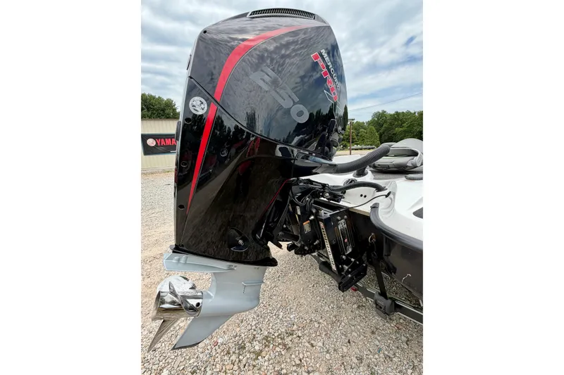 Slide: The Image of 2023 BassCat Erya boat with Mercury Pro XS outboard motor, parked on gravel. - 3