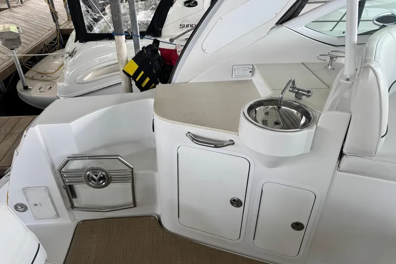 Slide: The Image of 2015 Cruisers Yachts 380 Express cockpit with sink and storage compartments. - 3